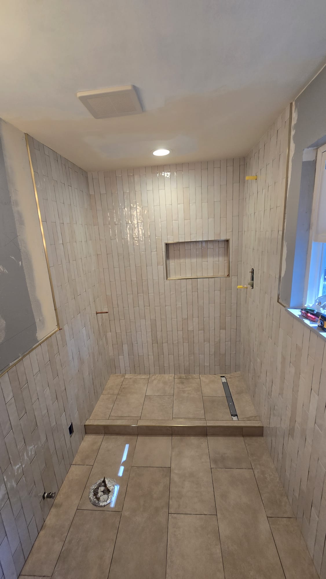 Tiled shower area prepared for a custom glass enclosure