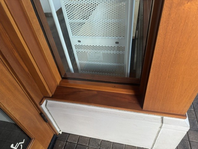 Detailed view of a commercial wood-framed glass window