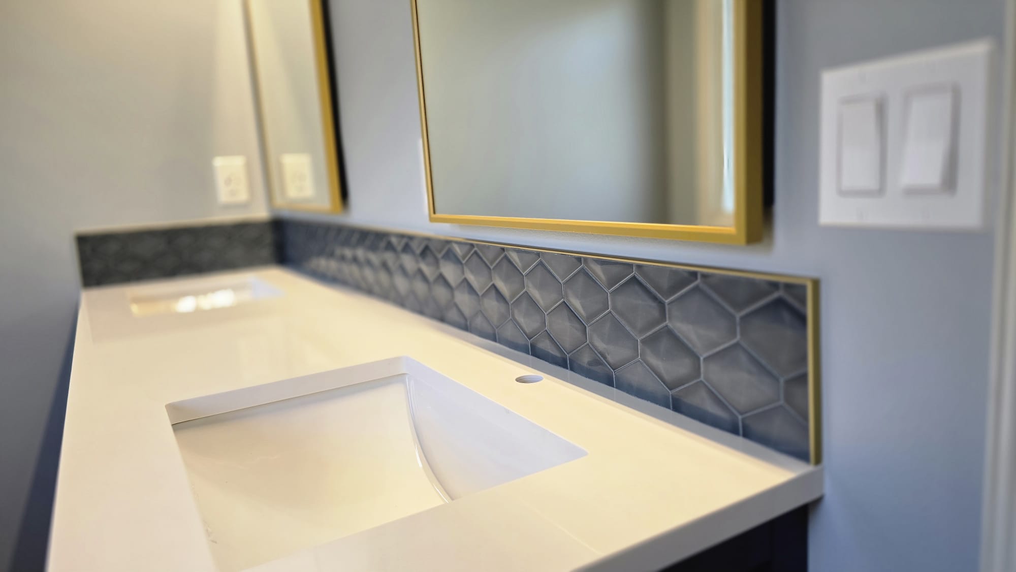 Pair of gold-framed bathroom mirrors
