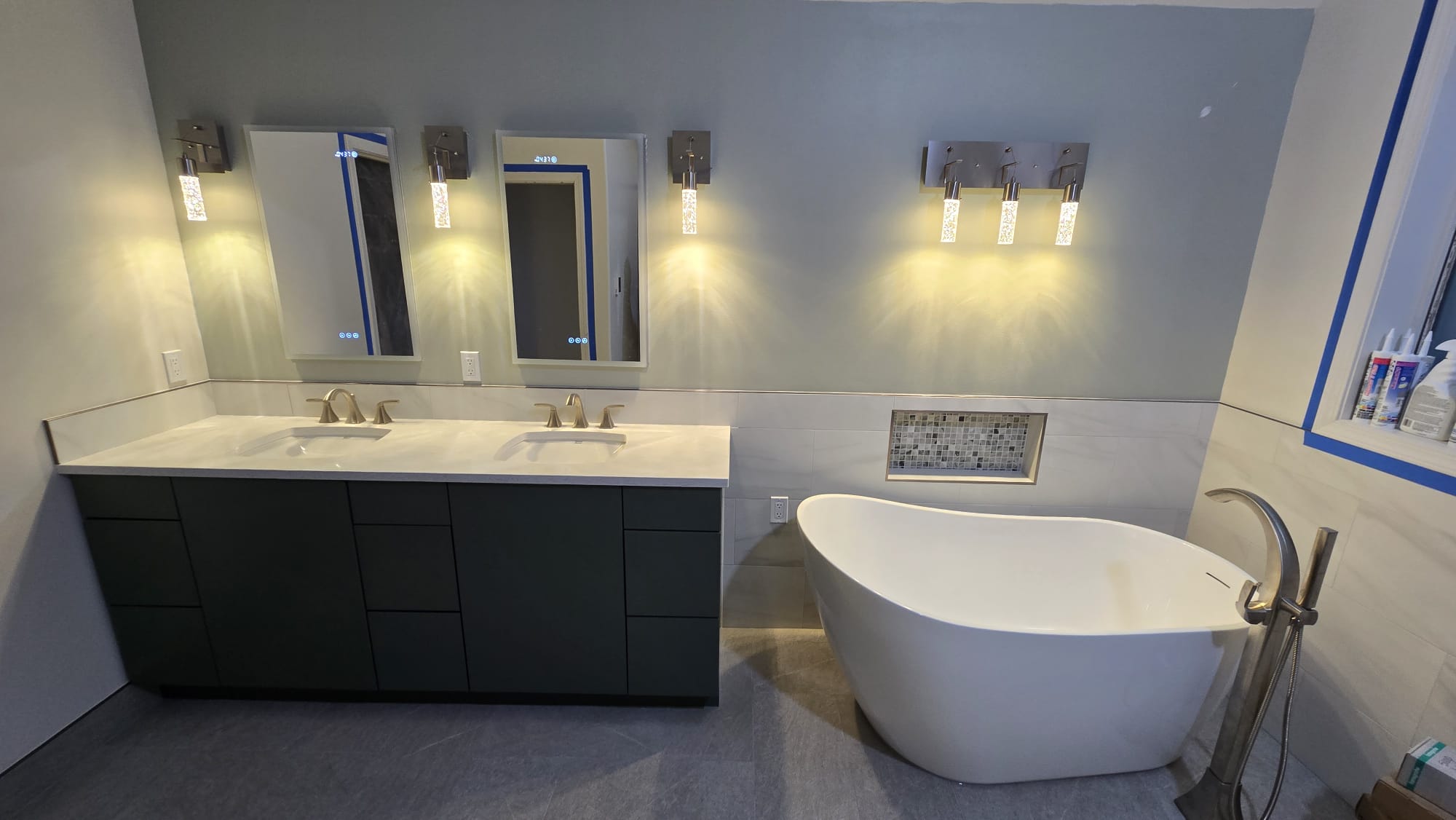 Bathroom renovation with illuminated vanity mirrors
